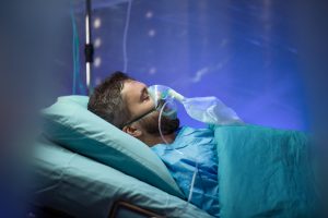 Infected patient in quarantine lying in bed in hospital, coronavirus concept