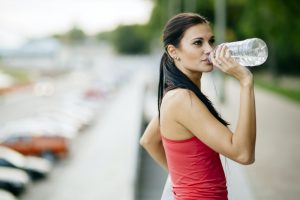 Attractive woman drinking water