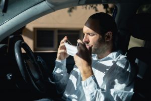 Caucasian man sitting in a car wearing a coronavirus covid19 mask
