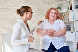 Female Psychiatrist Comforting Patient