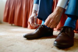 Groom is wearing shoes indoors