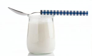 natural yogurt with spoon on white background