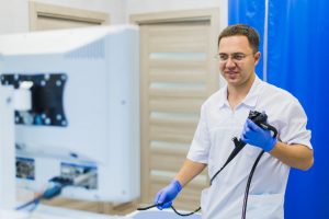 proctologist doctor holding Ligador hemorroidal in office