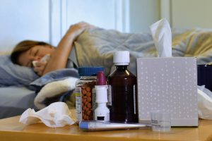 I feel awful!!! Laying in bed sick with the flu or cold - copy space