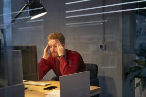 Tired businessman in office working late
