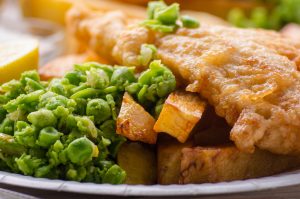 Traditional British street food fish and chips with mushy peas o