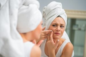 Woman squeezing pimple