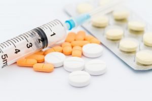 Medication in tablets and capsules and insulin syringe